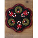 Black and red Christmas candle mat displayed on a table
