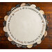 Isolated image of the Welcome Home Scalloped Table Topper on a wood background