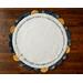 Circular scalloped table topper displayed on a dark wood table