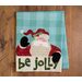 The Better Not Pout Santa Tea Towel laid flat on a table
