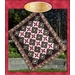 The front cover of the Black Beauty Quilt pattern showing the black and pink pieced patchwork quilt with floral accents.
