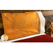 Bright orange pillowcase with monkeys and a fun accent stripe resting on a bed