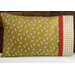 Bright green pillowcase with monkeys and a fun accent stripe resting on a bed