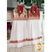 The two color variations of the La Rose Rouge Hanging Towels hung from a cabinet