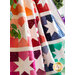 The beautiful Joyful Stars Quilt draped showing the ombre fabrics