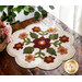 Adorable wool mat with appliqué flowers on a wood desk