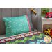 The On The Go Travel Size Pillowcase - Teal Airplanes resting on a kid's bed