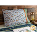The standard size Camp Woodland pillowcase in Light Blue displayed on a bed
