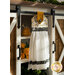 A white, yellow, and black Hanging Towel hung from a cabinet