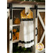 A yellow, white and black Hanging Towel hung from a cabinet