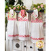 Three floral Sophie Hanging Towels hanging from a cabinet