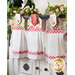 Three floral Sophie Hanging Towels hanging from a cabinet