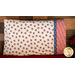 Patriotic pillowcase covered in red, white, and blue stars resting on a bed