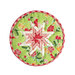 Green floral circular hot pad laid flat on a light teal table
