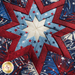 The center star design of the Liberty Lane Folded Star Hot Pad