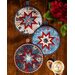 All three of the Liberty Lane Folded Star Hot Pads on a wood table