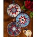 All three Liberty Lane Folded Star Hot Pads on a wood table