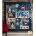 The finished Winter Solstice quilt displayed on a wood wall