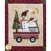 Block 9 of the Winter Wonderland Wool Quilt showing a snowman riding in a wagon with snowballs