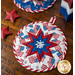 The white and blue coordinating America the Beautiful Folded Star Hot Pads on a wood table