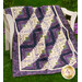 The beautiful Log Cabin Throw Size Quilt made with Violet Hill fabrics displayed on a wall
