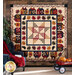 Geometric autumn themed quilt hung from a wall