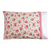 A beautiful red and white floral pillow on a bed