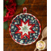 Navy blue floral circular hot pad on a wood table