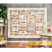 An adorable quilt with small square borders surrounding white embroidery blocks hung from a wall