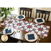 A beautiful patriotic table runner set in the center of a dark wood table