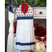 The patriotic red, white, and blue patriotic hanging towel hung from a cabinet