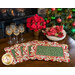 Four beautiful Christmas-themed scalloped placemats on a dark wood table