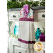 A black, red, and white Christmas hanging towel hung from a cabinet