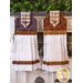 The coordinating purple and brown Blessings of Home Hanging Towels hung on a cabinet
