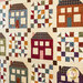 A close up of a quilt with house block and checkered lattice designs