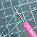 A close up of the pointed seam ripper point and safety ball