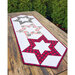 Quilted table runner featuring hollow stars design in red and black
