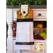 White hanging towel with rich earth toned grape pattern.