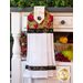 White hanging towel with rich earth toned pomegranate pattern.