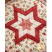 A folded star design on a hot pad with white and pink floral fabrics.