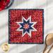 Red hot pad made with patriotic phrase motif fabric, featuring a central star and navy blue border.
