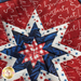 Red hot pad made with patriotic phrase motif fabric, featuring a central star and navy blue border.