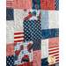 Close up of quilt blocks featuring patriotic stars, stripes and phrases.
