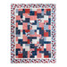 Hanging quilt filled with red white and blue patriotic imagery.