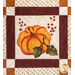 Quilt block featuring a pumpkin and acorns.