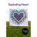 The front of the Exploding Heart pattern showing the finished quilt in a field of grass
