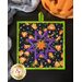 Square hot pad with central folded star design featuring Halloween themed fabrics.