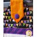 Hanging towel with Halloween colors and pennant imagery.