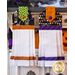 Two hanging towels with Halloween colors, Halloween imagery, and white waffle texture.