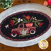 Wool appliqué truck with florals in metal plate.